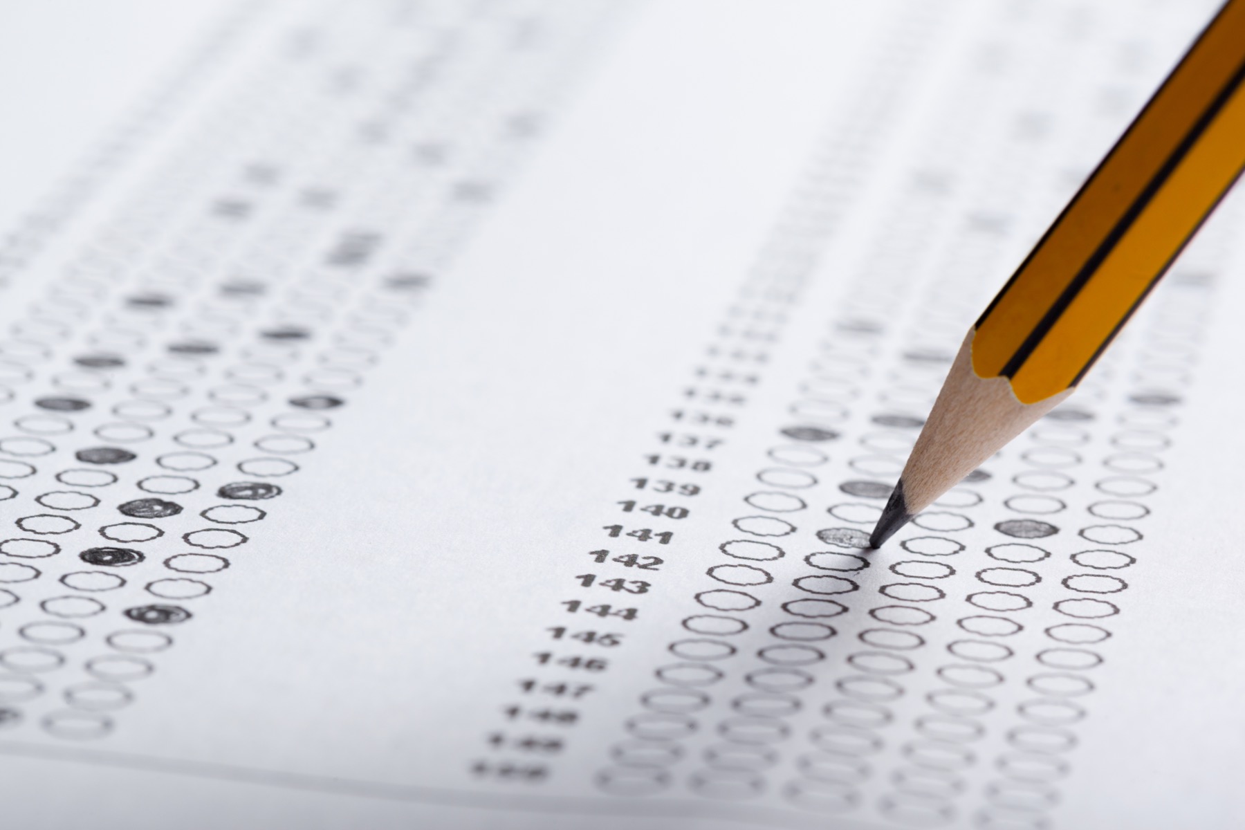 Pencil filling in answers on a standardized assessment form