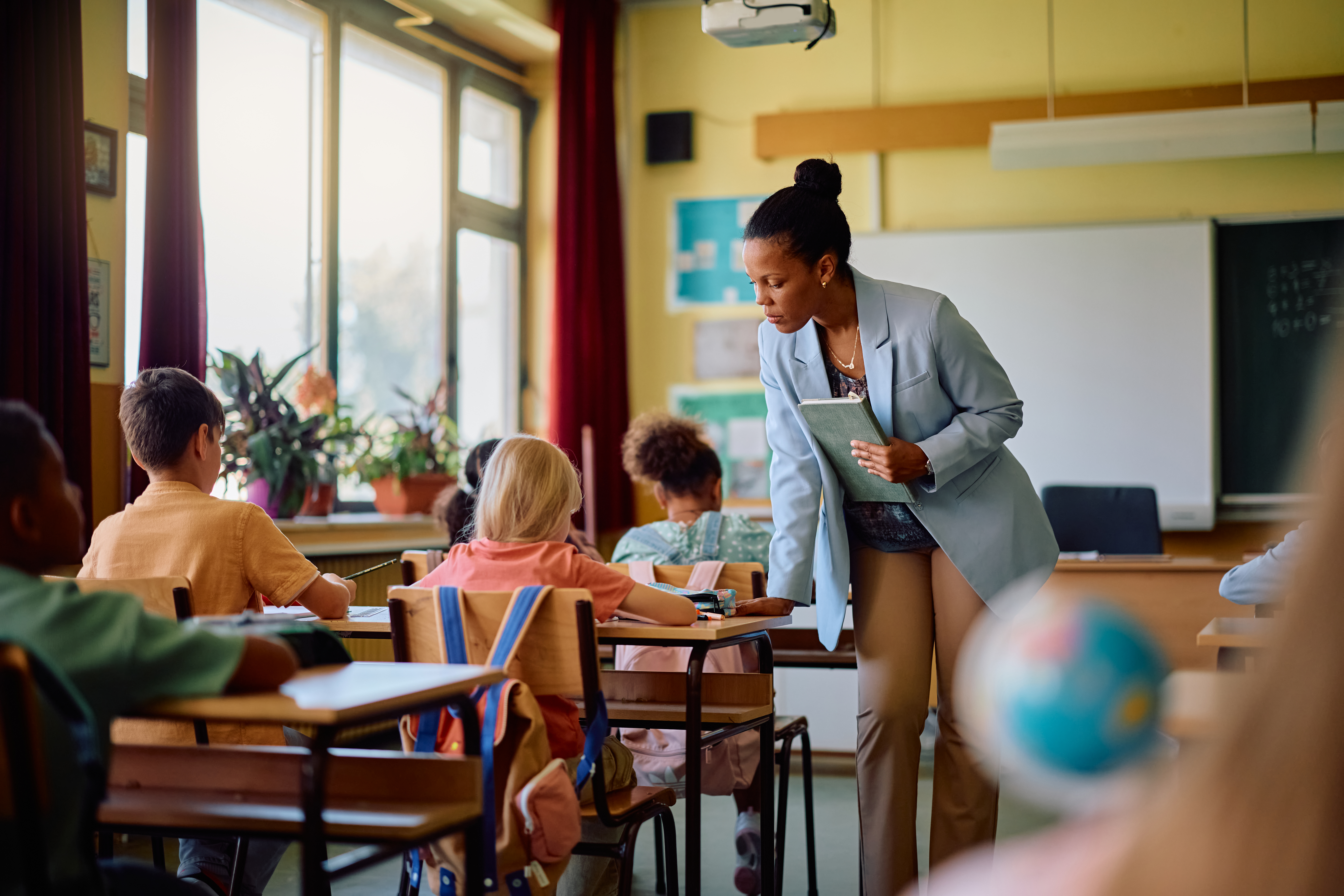 Teacher supporting students in a classroom