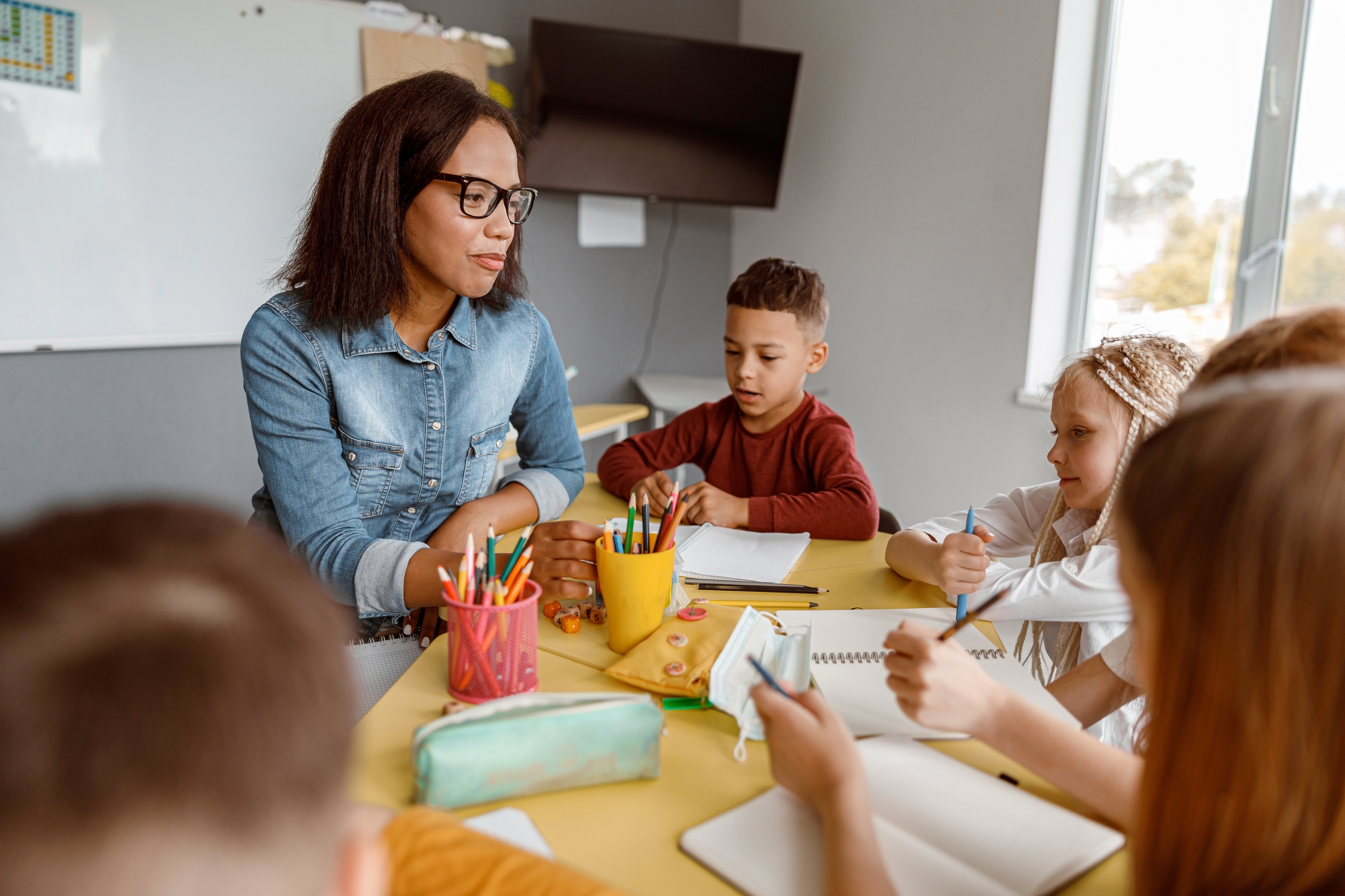 Teacher supporting students during small-group classroom work